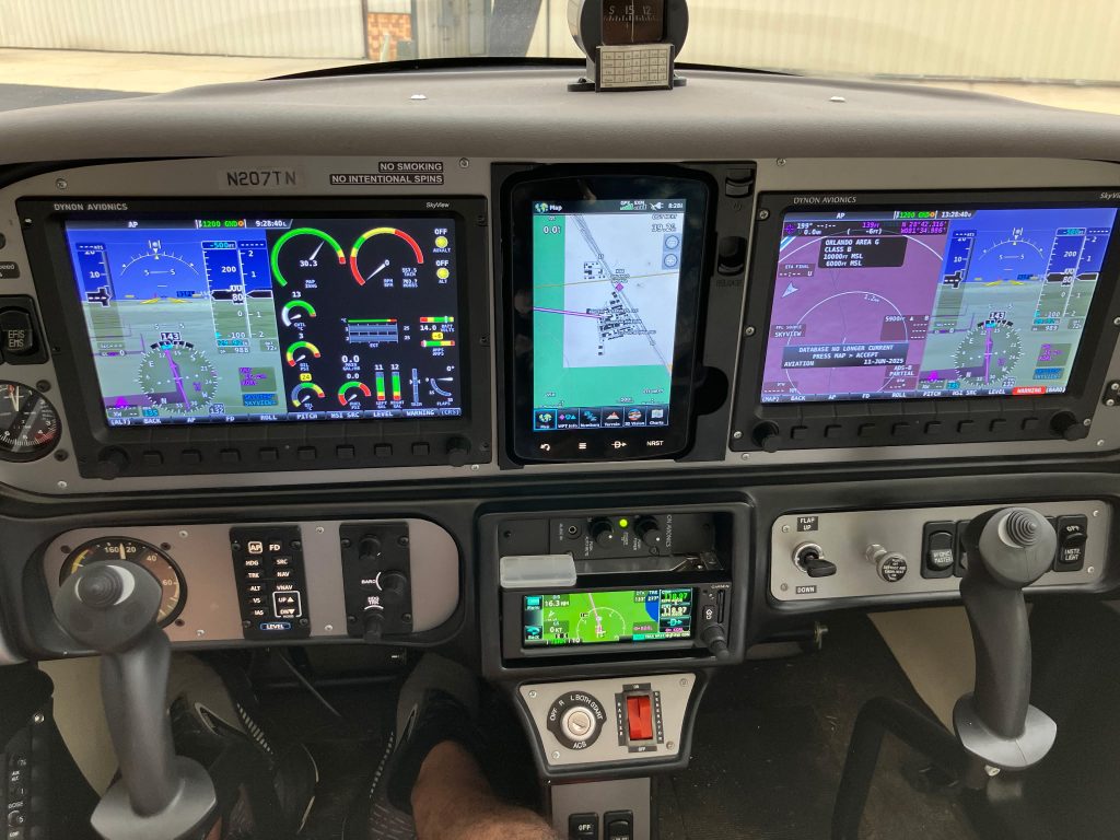 N207TN Cockpit - Countrywide Flyers | Orlando Apopka X04 Cockpit of a small aircraft with three large digital screens showing flight instruments and navigation.