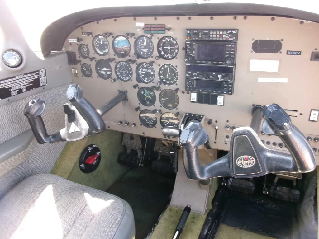 N4161Z Panel - Countrywide Flyers | Orlando Apopka X04 Cockpit interior of a small airplane with dual yokes, analog gauges, and an avionics stack.