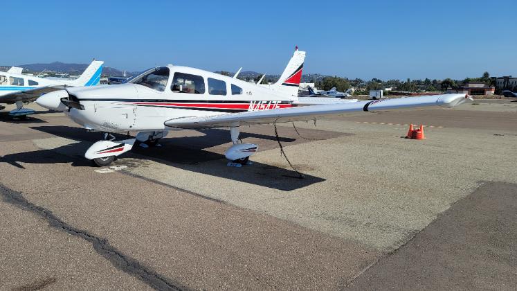 N4547F 1 - Countrywide Flyers | Orlando Apopka X04 Small white single-engine airplane parked on a tarmac with wheel chocks, other light aircraft in the background, and orange cones on the apron.